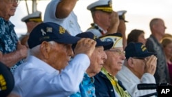 FILE - Pearl Harbor survivors, from left, Harry Chandler, Ken Stevens, Herb Elfring and Ira "Ike" Schab salute while the national anthem is played during the 82nd Pearl Harbor Remembrance Day ceremony on Dec. 7, 2023, at Pearl Harbor in Honolulu, Hawaii.