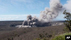 In this May 11, 2018, photo released by the U.S. Geological Survey, a weak ash plume rises from the Overlook Vent in Halema'uma'u crater of the Kilauea volcano on the Big Island of Hawaii. Geologists warn that the volcano could shoot out large boulders and ash out of its summit crater.