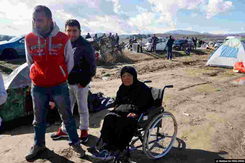 A wheelchair-bound migrant woman waits in a makeshift refugee camp in the northern Greek border town of Idomeni, seeking passage to another European destination, March 4, 2016.