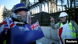 A pro-Brexit protester argues wth anti-Brexit campaigner Steve Bray outside the Houses of Parliament in London, Jan. 28, 2019.