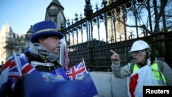 FILE - A pro-Brexit protester argues wth anti-Brexit campaigner Steve Bray outside the Houses of Parliament in London, Jan. 28, 2019.