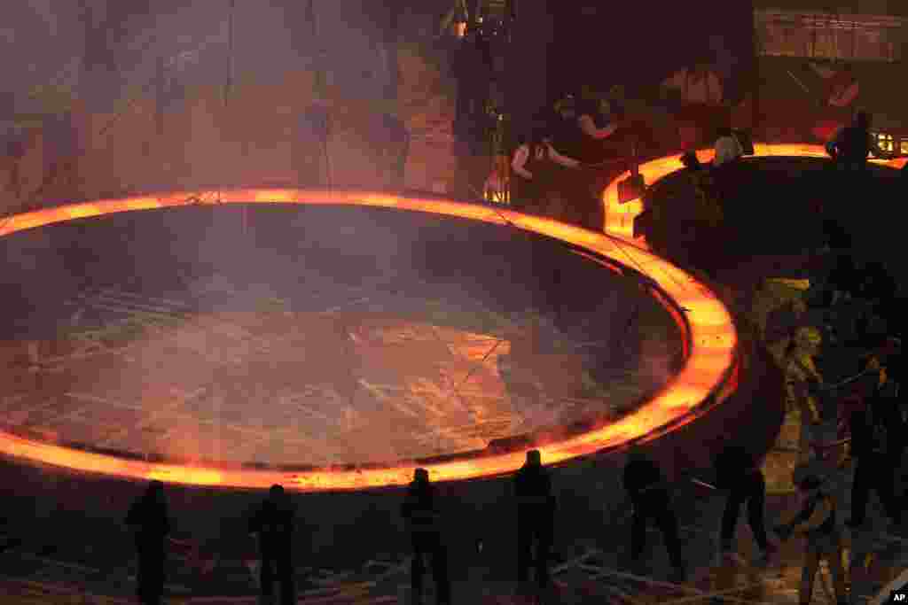 Performers depict a view of the Industrial Revolution during the Opening Ceremony of the 2012 Olympic Summer Games at the Olympic Stadium in London, July 27, 2012.