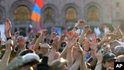 Supporters of opposition lawmaker Nikol Pashinian protest in Republic Square in Yerevan on Wednesday, May 2, 2018. Pashinyan has urged his supporters to block roads, railway stations and airports on Wednesday after the governing Republican Party voted against his election as prime minister.