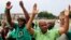 Joseph Mathunjwa (R), president of South Africa's Association of Mineworkers and Construction Union (AMCU), arrives to address members of the mining community during a rally in Rustenburg, northwest of Johannesburg Jan.19, 2014.