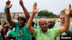 Joseph Mathunjwa (R), president of South Africa's Association of Mineworkers and Construction Union (AMCU), arrives to address members of the mining community during a rally in Rustenburg, northwest of Johannesburg, Jan.19, 2014.