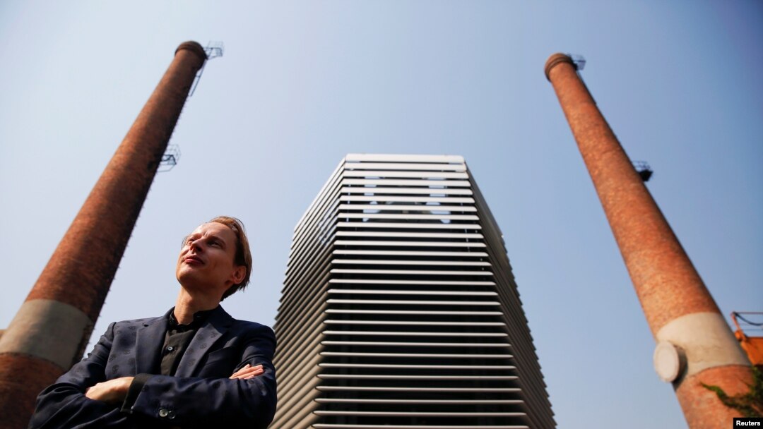 Dutch artist and innovator Daan Roosegaarde poses in front of the Smog Free Tower, the world's largest smog vacuum cleaner as he presents his The Smog Free Project at D-751 art zone in Beijing, September 29, 2016.