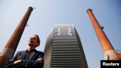 Dutch artist and innovator Daan Roosegaarde poses in front of the Smog Free Tower, the world's largest smog vacuum cleaner as he presents his The Smog Free Project at D-751 art zone in Beijing, September 29, 2016.