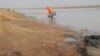 Villagers gather to catch fish in Trapaing Thmar reservoir as the drought continues to hit the community, in Banteay Meanchey, Feb. 23, 2019. (Sun Narin/VOA Khmer)