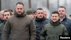 FILE - Ukrainian President Volodymyr Zelenskiy, right, and Andriy Yermak, left, a senior aide whom Zelenskiy appointed chief of staff, visit the frontlines in Ukraine's war with Russia-backed separatists, in Stanytsia Luhanska, Nov. 20, 2019. 