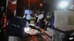 Electoral officials count ballot papers under a lantern light at the end of voting at a polling station in Monrovia, Liberia, Oct. 10, 2017. 