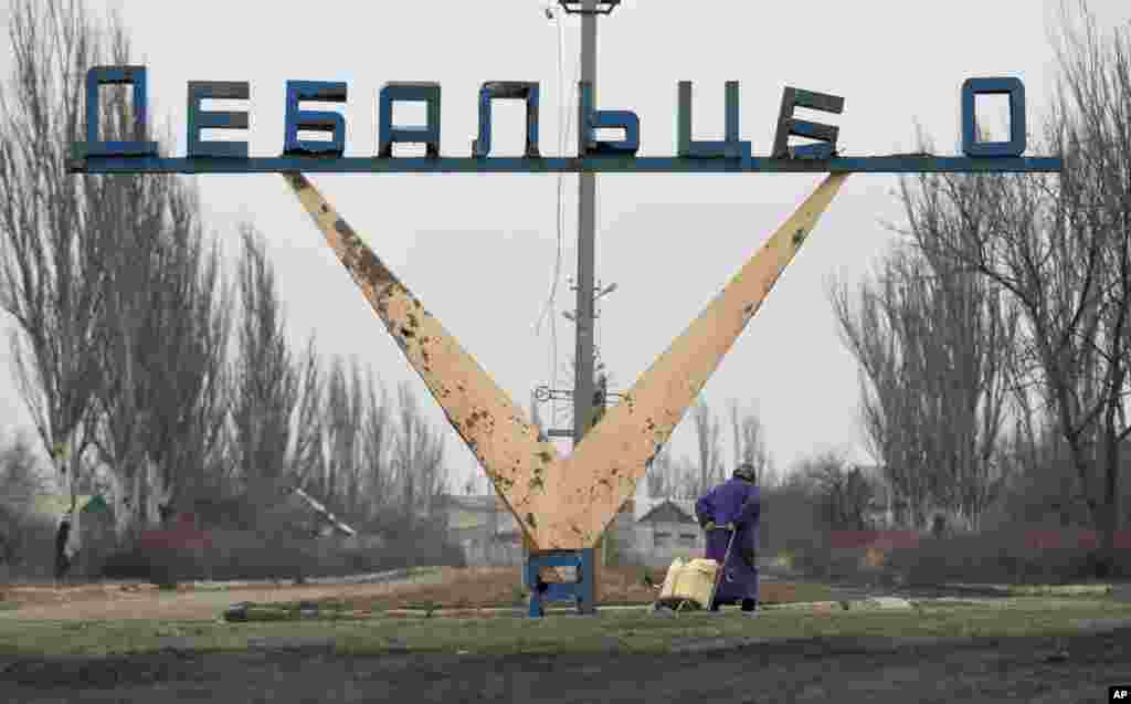 An elderly woman drags a cart with her belongings on the outskirts of Debaltseve. After weeks of relentless fighting the embattled Ukrainian rail hub of Debaltseve fell last week to Russia-backed separatists.