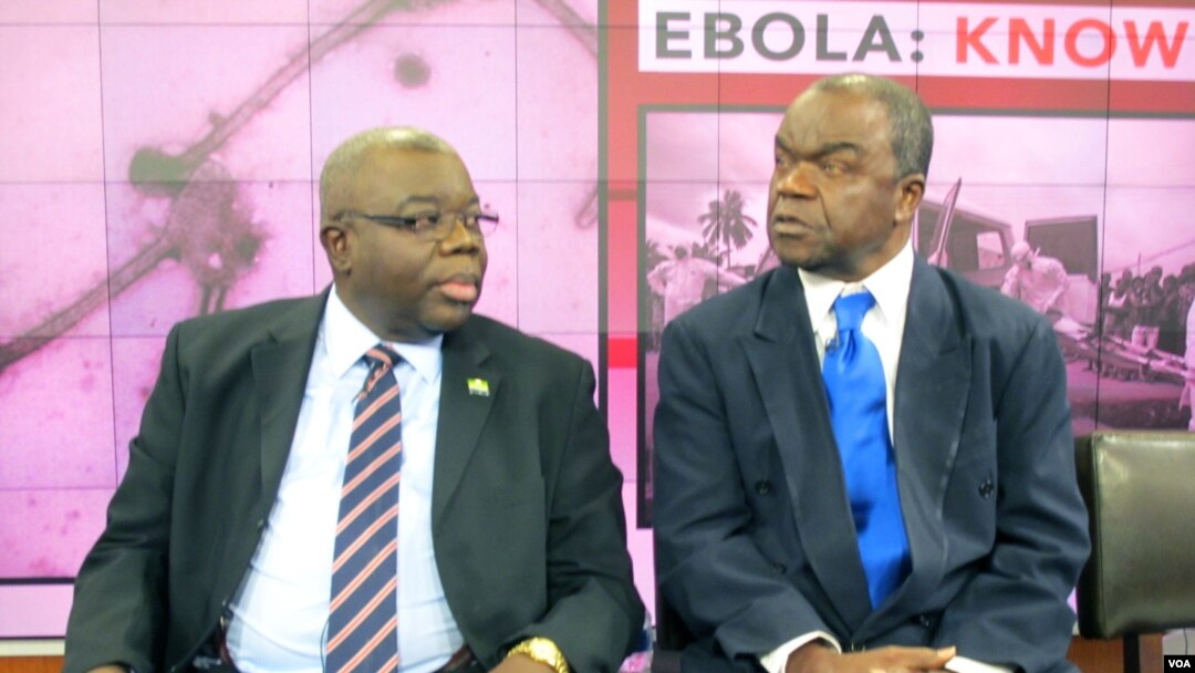 H.E. Bockari Stevens, Sierra Leone's ambassador to the United States, chats with Malonga Miatudila, a physician and Ebola expert, at VOA in Washington, Nov. 19, 2014.