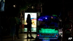 FILE - Sex workers stand in a largely shut-down red light area in Bangkok, Thailand, March 26, 2020.