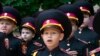Young cadets sing the national anthem during rehearsal of a ceremony on the first day of school at a cadet lyceum in Kyiv, Ukraine, Sept. 1, 2022.