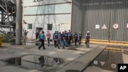 In this handout photo taken from video released by the Russian Defense Ministry Press Service Sept. 2, 2022, members of International Atomic Energy Agency walk while inspecting the Zaporizhzhia Nuclear Power Plant in Enerhodar, southeastern Ukraine, Sept. 1, 2022.