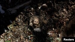 A vintage doll is pictured near a damaged kindergarten following recent Russian shelling in the city of Slovyansk, in Donetsk region, Ukraine.