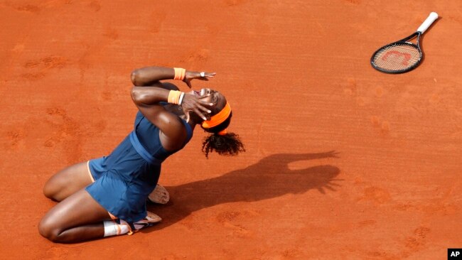 FILE - Serena Williams celebrates as she defeats Russia's Maria Sharapova during the women's final match of the French Open tennis tournament at Roland Garros stadium June 8, 2013, in Paris.