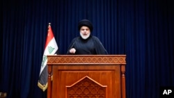 Influential Shiite cleric Muqtada al-Sadr, makes a speech calling on his supporters to withdraw from the capital's government quarter, from his house in Najaf, Iraq, Aug. 30, 2022.