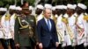U.S. Ambassador to Sudan John Godfrey, the first U.S. ambassador to Sudan in 25 years, walks alongside a presidential guard during a ceremony at the presidential palace in Khartoum on Sept. 1, 2022. 