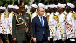 U.S. Ambassador to Sudan John Godfrey, the first U.S. ambassador to Sudan in 25 years, walks alongside a presidential guard during a ceremony at the presidential palace in Khartoum on Sept. 1, 2022. 