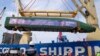 Workers unload part of a Chinese-made high-speed passenger train — prepared for the Jakarta-Bandung High-Speed Railway — from a cargo ship at Tanjung Priok Port in Jakarta, Indonesia, in September 2022.