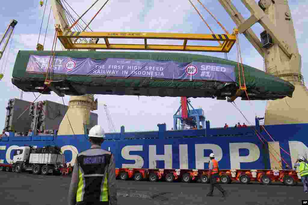 Workers unload part of a Chinese-made high-speed passenger train — prepared for the Jakarta-Bandung High-Speed Railway — from a cargo ship at Tanjung Priok Port in Jakarta, Indonesia. 