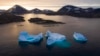 FILE - Large icebergs float away as the sun rises near Kulusuk, Greenland, Aug. 16, 2019. 