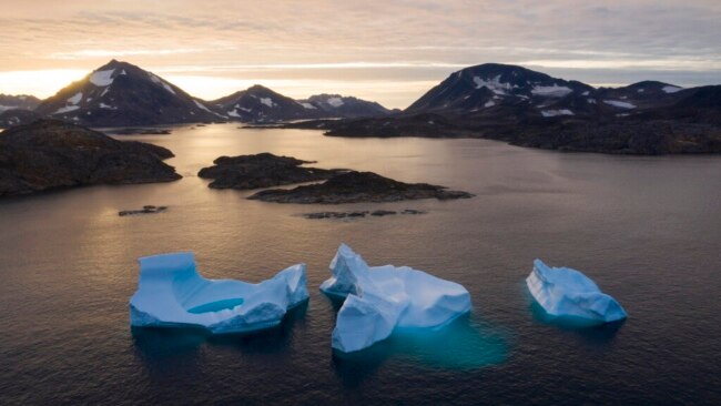 FILE - Large icebergs float as the sun rises near Kulusuk, Greenland, Aug. 16, 2019.