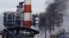FILE - Smoke billows from an oil refinery owned by Russian oil producer Gazprom Neft, in Moscow, Russia, Nov. 17, 2018. 