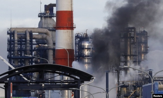 FILE - Smoke billows from an oil refinery owned by Russian oil producer Gazprom Neft, in Moscow, Russia, Nov. 17, 2018.