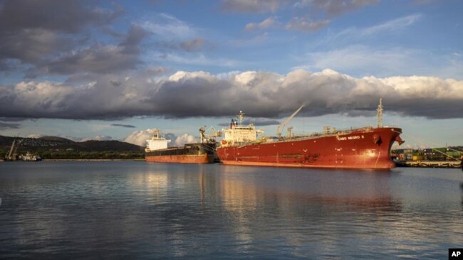 A coal barge and oil ship in Honolulu after the state received its last coal shipment, July 28, 2022. (Hawaii State Energy Office via AP)