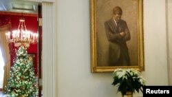 A portrait of former U.S. President John F. Kennedy hangs outside the Red Room during a press tour of White House Christmas decorations ahead of holiday receptions by U.S. President Joe Biden and first lady Jill Biden, November 29, 2021.