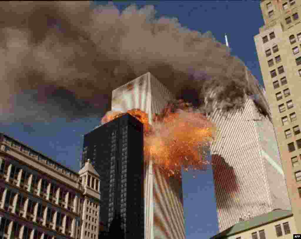 THIRD OF A SERIES OF FOUR PHOTOS--Smoke billows from one of the towers of the World Trade Center and flames and debris explode from the second tower, Tuesday, Sept. 11, 2001. In one of the most horrifying attacks ever against the United States, terrorists