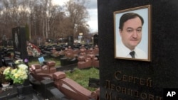 FILE - A tombstone on the grave of lawyer Sergei Magnitsky who died in jail, at a cemetery in Moscow, Nov. 16, 2012.