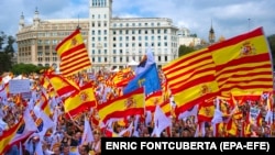 SPAIN - Demonstrators hold Spanish and Catalonian flags as they take part in a rally to mark Spain's National Day in Barcelona, northeastern Spain, 12 October 2017