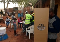 A man prepares to cast his ballot at a polling station during the second round of Guinea Bissau's presidential election in Bissau, Guinea-Bissau Dec. 29, 2019.