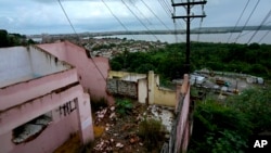 FILE - Homes stand abandoned due to ground subsidence caused by the Braskem mine in the Bebedouro neighborhood of Maceio, Alagoas state, Brazil, March 7, 2022.