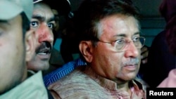 Pakistan's former president and head of the All Pakistan Muslim League (APML) political party Pervez Musharraf (R) is escorted by security officials as he leaves an anti-terrorism court in Islamabad, April 20, 2013. 