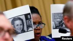 Rep. Sheila Jackson Lee, D-Texas, holds up pictures of women, left, who are accusing Alabama Republican Senate candidate Roy Moore, shown right, as she questions Attorney General Jeff Sessions during a House Judiciary Committee hearing on Capitol Hill, Tuesday, Nov. 14, 2017 in Washington.