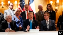President Donald Trump speaks with reporters about border policy during a fundraising event, April 10, 2019, in San Antonio, Texas.