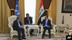 United Nations Secretary-General Antonio Guterres, left, meets with Iraqi parliament speaker Salim al-Jabouri, right, in Baghdad, March 30, 2017.