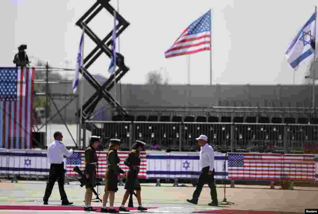 Israeli soldiers walk towards their positions as they prepare for an official ceremony to welcome U.S. President Barack Obama at Ben Gurion International Airport, near Tel Aviv, Israel, March 20, 2013. 