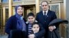 Nezha Hariz, left, poses with husband Mohamed Hariz and sons Nassim, 9, and Mouad, 7, outside a federal courthouse where they became U.S. citizens, March 18, 2016. The New York state family is from Morocco.
