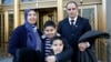 Nezha Hariz, left, poses with husband Mohamed Hariz and sons Nassim, 9, and Mouad, 7, outside a federal courthouse where they became U.S. citizens, March 18, 2016. The New York state family is from Morocco.