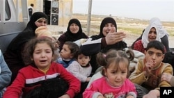 Civilians flee fighting after Syrian army tanks enter northwestern city of Idlib, Syria, Feb. 14, 2012.