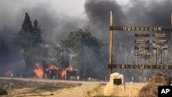 The Klamathon Fire left Hornbrook, Calif., charred, July 6, 2018. Siskiyou County Board of Supervisors chair Ray Haupt says the blaze moved so fast it quickly reached Hornbrook, a community of about 250 people about 14 miles (22 kilometers) south of the