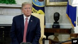 President Donald Trump in the Oval Office of the White House, April 10, 2018, in Washington.