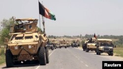 FILE - Afghan forces prepare for battle with Taliban on outskirts of Kunduz, June 2015.