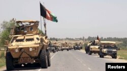 FILE - Afghan forces prepare for battle with Taliban on the outskirts of Kunduz city, northern Afghanistan, June 21, 2015. 