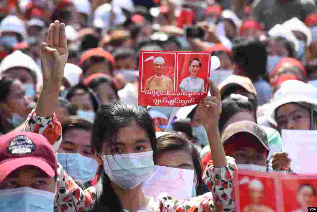 People holding images of detained civilian leader Aung San Suu Kyi and President Win Myint call for their release during a rally against the military coup in Yangon, Myanmar, Feb. 7, 2021. (Credit: VOA Burmese Service)